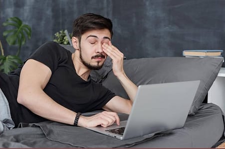 man falling asleep using laptop.adrenal burnout maybe